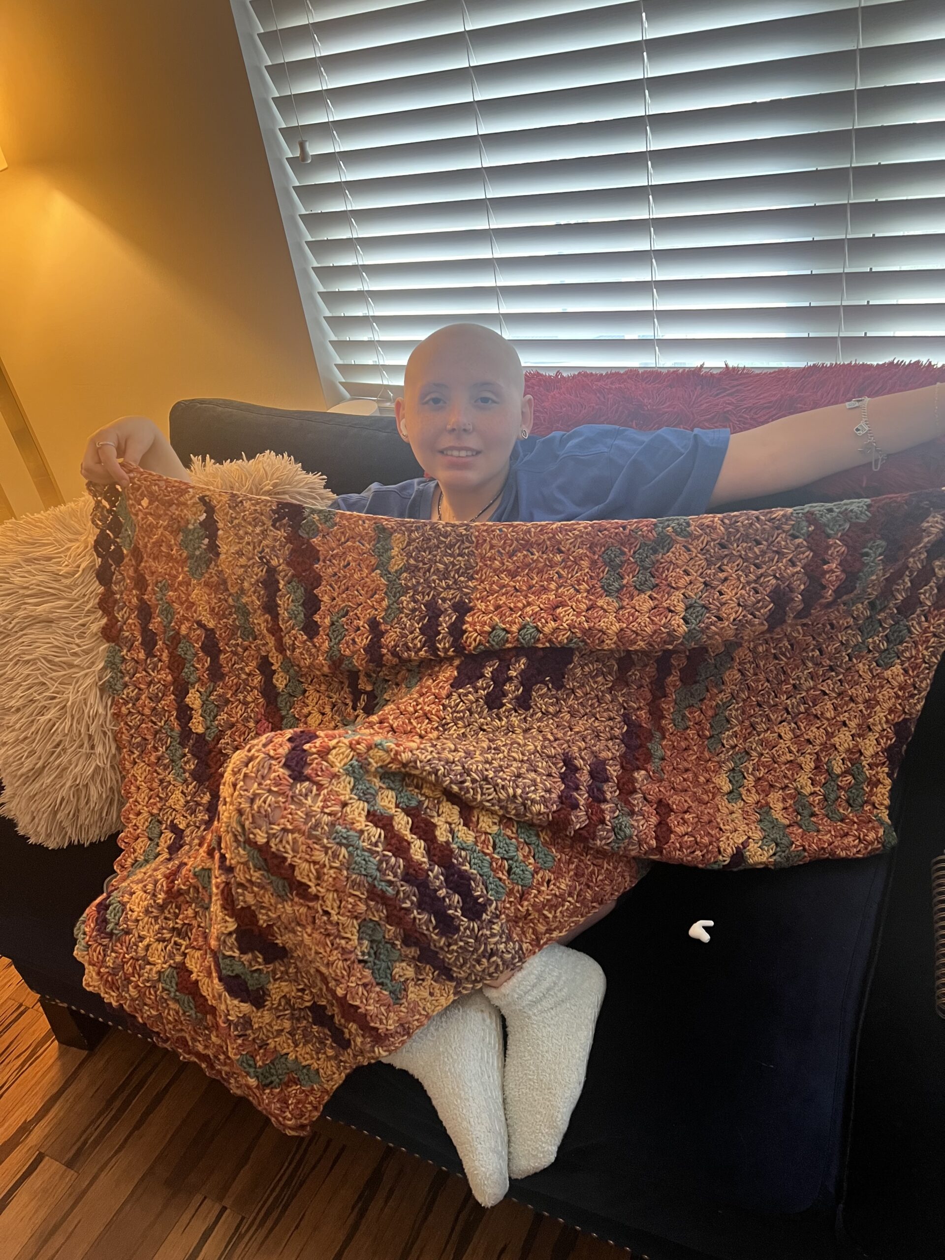 Jillian poses with a blanket donated by a CCP donor